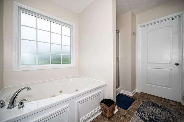 2480 Mount Lebanon Rd, Lewisburg, TN 37091 - full bath with stone finish flooring, a tub with jets, a shower stall, and baseboards