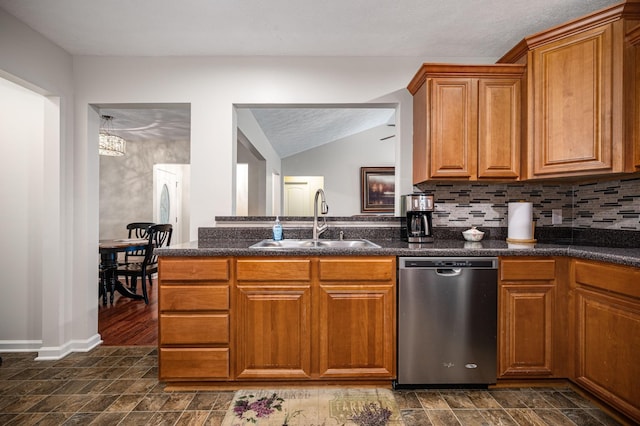 2480 Mount Lebanon Rd, Lewisburg, TN 37091 - kitchen featuring stainless steel dishwasher, a sink, brown cabinetry, decorative backsplash, and lofted ceiling