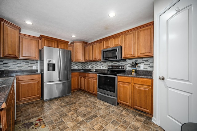 2480 Mount Lebanon Rd, Lewisburg, TN 37091 - kitchen featuring stainless steel appliances, stone finish flooring, brown cabinets, backsplash, and recessed lighting