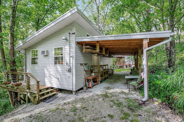 192 Askin Ln, Baxter, TN 38544 - view of property exterior featuring a carport and an AC wall unit