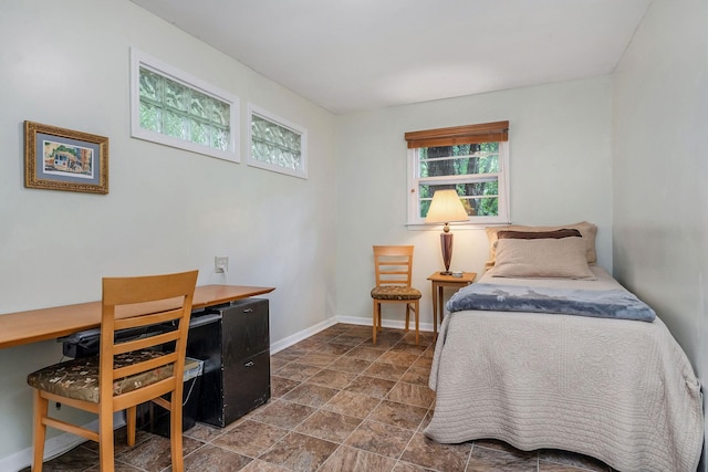 192 Askin Ln, Baxter, TN 38544 - bedroom featuring multiple windows, an office area, stone finish flooring, and baseboards