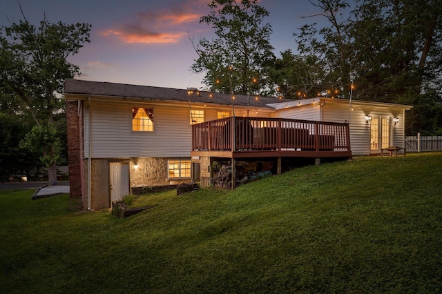 1310 Tabitha Dr, Hixson, TN 37343 - back of house at dusk with a wooden deck and a lawn