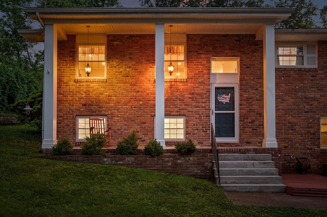 1310 Tabitha Dr, Hixson, TN 37343 - view of front of house featuring brick siding, a front lawn, and a porch