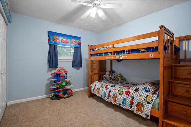 1310 Tabitha Dr, Hixson, TN 37343 - carpeted bedroom featuring a textured ceiling, a closet, baseboards, and ceiling fan