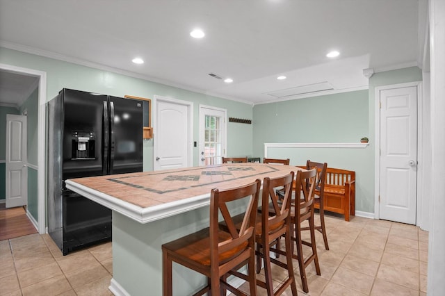 1310 Tabitha Dr, Hixson, TN 37343 - kitchen with black refrigerator with ice dispenser, tile counters, crown molding, light tile patterned flooring, and recessed lighting