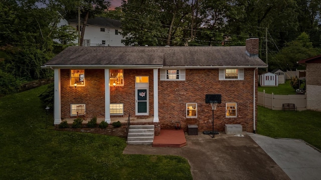 1310 Tabitha Dr, Hixson, TN 37343 - bi-level home featuring a chimney, a front yard, and brick siding