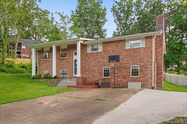 1310 Tabitha Dr, Hixson, TN 37343 - view of front facade with a chimney, brick siding, driveway, and cooling unit