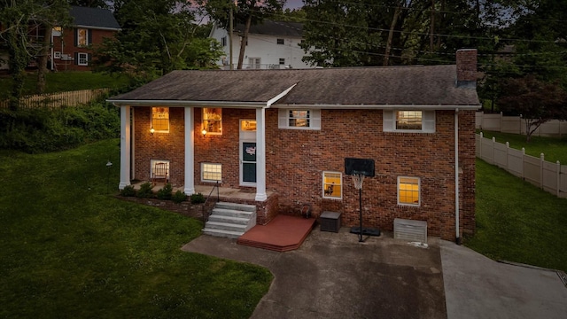 1310 Tabitha Dr, Hixson, TN 37343 - view of front facade featuring a chimney, brick siding, and a patio