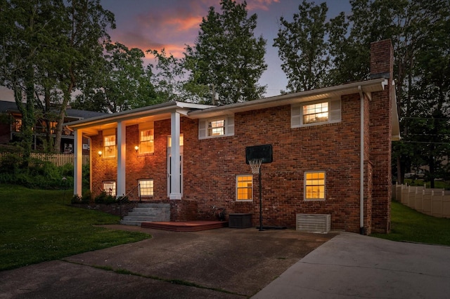 1310 Tabitha Dr, Hixson, TN 37343 - view of front facade featuring a chimney, brick siding, and cooling unit