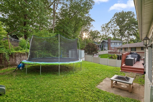 1310 Tabitha Dr, Hixson, TN 37343 - view of yard with a trampoline, an outdoor fire pit, and a wooden deck