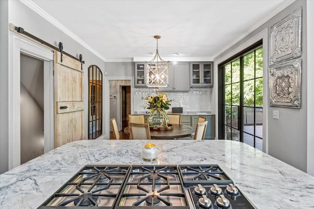 5400 Hillsboro Pike, Nashville, TN 37215 - kitchen with a barn door, stainless steel gas cooktop, gray cabinets, decorative backsplash, and glass insert cabinets