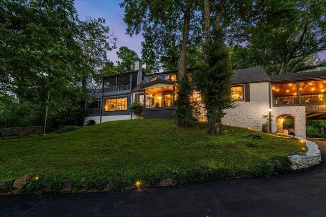 5400 Hillsboro Pike, Nashville, TN 37215 - view of front of property featuring a sunroom, a front yard, stone siding, and a chimney