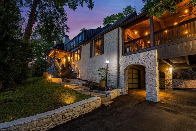 5400 Hillsboro Pike, Nashville, TN 37215 - view of front of home featuring stone siding, a chimney, and driveway
