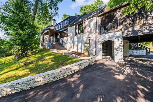 5400 Hillsboro Pike, Nashville, TN 37215 - view of front of house featuring stairs, a front lawn, a chimney, and a balcony