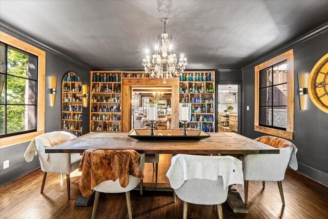 5400 Hillsboro Pike, Nashville, TN 37215 - dining room featuring a chandelier, crown molding, baseboards, wood finished floors, and built in shelves