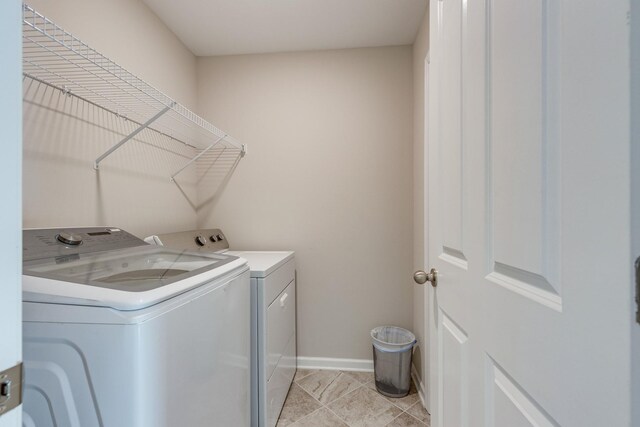 221 Kinsale Dr, Spring Hill, TN 37174 - washroom featuring washing machine and clothes dryer, baseboards, and light tile patterned flooring