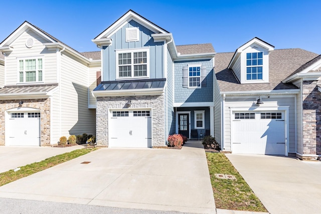 221 Kinsale Dr, Spring Hill, TN 37174 - view of front facade featuring concrete driveway, stone siding, board and batten siding, and roof with shingles