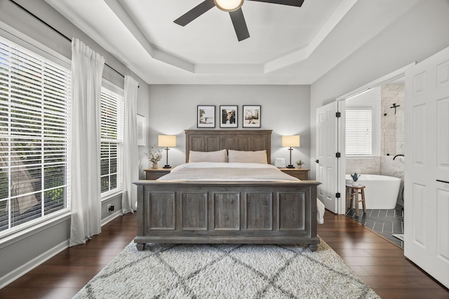 5517 Nevil Pt, Brentwood, TN 37027 - bedroom featuring dark wood-style flooring, a tray ceiling, and a ceiling fan