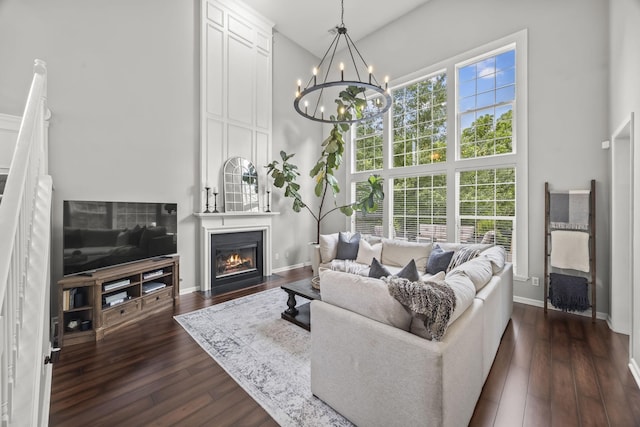5517 Nevil Pt, Brentwood, TN 37027 - living room with a high ceiling, a chandelier, a large fireplace, baseboards, and dark wood-style flooring