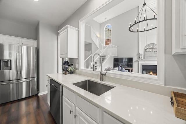 5517 Nevil Pt, Brentwood, TN 37027 - kitchen with stainless steel appliances, a sink, light countertops, dark wood-style floors, and white cabinetry