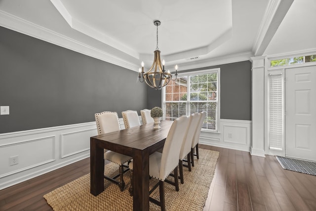 5517 Nevil Pt, Brentwood, TN 37027 - dining area featuring a raised ceiling, a chandelier, dark wood-type flooring, wainscoting, and a decorative wall