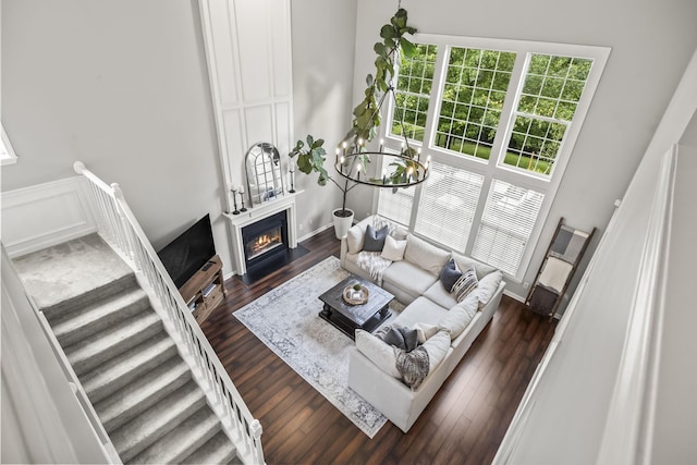 5517 Nevil Pt, Brentwood, TN 37027 - living area with a chandelier, a fireplace with flush hearth, dark wood-type flooring, stairs, and baseboards