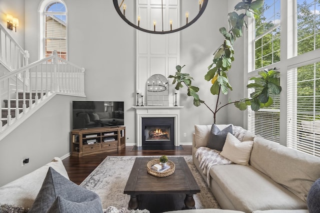 5517 Nevil Pt, Brentwood, TN 37027 - living area with a high ceiling, stairs, wood finished floors, baseboards, and a large fireplace