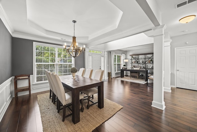 5517 Nevil Pt, Brentwood, TN 37027 - dining space with ornate columns, healthy amount of natural light, a tray ceiling, hardwood / wood-style flooring, and wainscoting