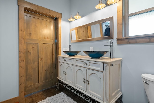 4499 Benson Rd, Springfield, TN 37172 - bathroom featuring double vanity, toilet, and wood finished floors