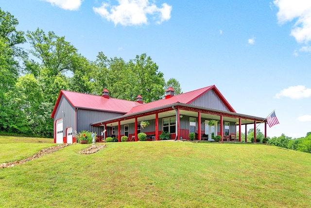 4499 Benson Rd, Springfield, TN 37172 - view of front of house with a front yard, a chimney, metal roof, and a detached garage