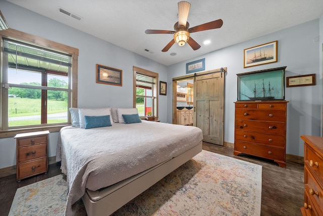 4499 Benson Rd, Springfield, TN 37172 - bedroom with a barn door, dark wood-style flooring, recessed lighting, ceiling fan, and baseboards