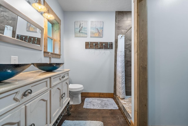 4499 Benson Rd, Springfield, TN 37172 - full bath featuring wood finished floors, double vanity, a stall shower, and toilet