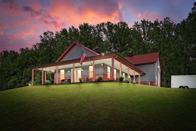 4499 Benson Rd, Springfield, TN 37172 - view of front of house featuring a lawn, a chimney, board and batten siding, and metal roof