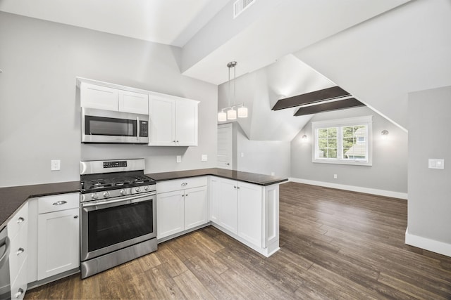 2107 Kidd Rd, Nolensville, TN 37135 - kitchen featuring appliances with stainless steel finishes, a peninsula, open floor plan, dark countertops, and dark wood finished floors