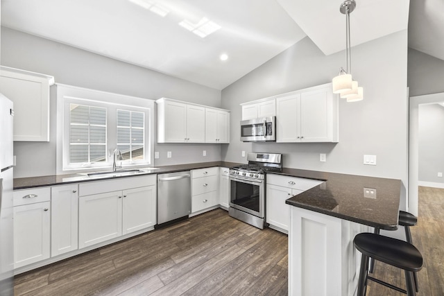 2107 Kidd Rd, Nolensville, TN 37135 - kitchen with appliances with stainless steel finishes, lofted ceiling, a peninsula, a sink, and dark wood-style flooring