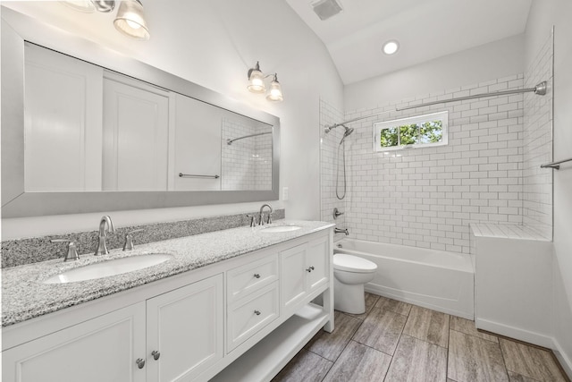 2107 Kidd Rd, Nolensville, TN 37135 - full bathroom with  shower combination, double vanity, toilet, vaulted ceiling, and wood finished floors