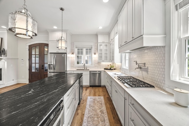 2107 Kidd Rd, Nolensville, TN 37135 - kitchen with appliances with stainless steel finishes, light wood finished floors, tasteful backsplash, arched walkways, and recessed lighting