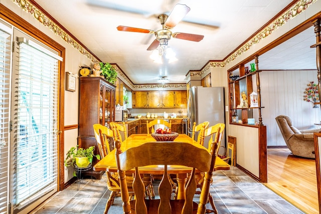 406 Longview St, Camden, TN 38320 - dining space featuring healthy amount of natural light, a ceiling fan, and wood walls