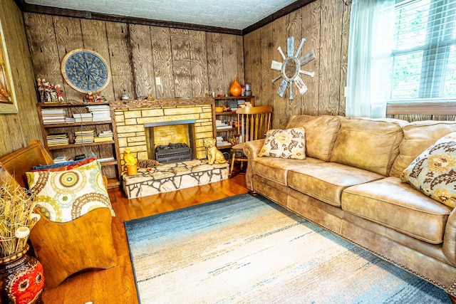 406 Longview St, Camden, TN 38320 - living room with wood finished floors, wooden walls, and a stone fireplace