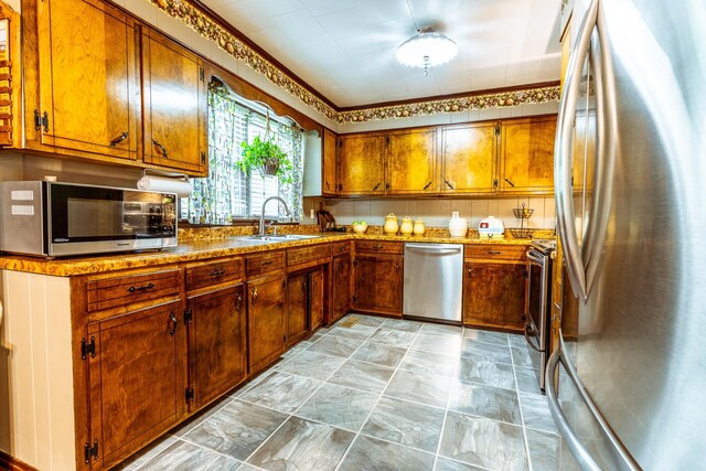 406 Longview St, Camden, TN 38320 - kitchen featuring stainless steel appliances, a sink, and brown cabinetry