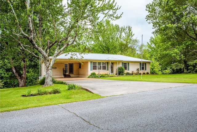 406 Longview St, Camden, TN 38320 - ranch-style home featuring concrete driveway, a front yard, and a carport