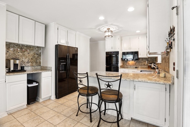 5720 Saint Charles Ct, Hermitage, TN 37076 - kitchen featuring black appliances, tasteful backsplash, a peninsula, a sink, and white cabinetry