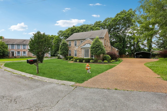 5720 Saint Charles Ct, Hermitage, TN 37076 - view of front of home featuring a detached carport, driveway, brick siding, and a front lawn
