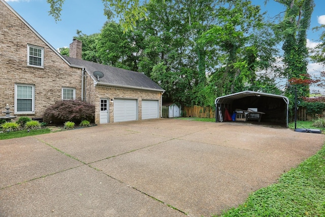 5720 Saint Charles Ct, Hermitage, TN 37076 - view of property exterior with a detached carport, a chimney, concrete driveway, an attached garage, and brick siding