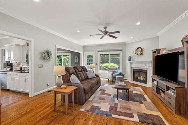 440 Ridgestone Dr, Franklin, TN 37064 - living area featuring light wood finished floors, plenty of natural light, ceiling fan, a fireplace, and crown molding