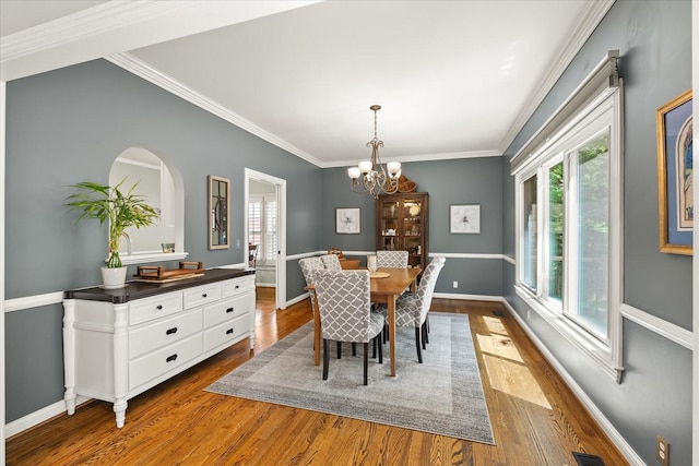 440 Ridgestone Dr, Franklin, TN 37064 - dining room with healthy amount of natural light, dark wood-style floors, a chandelier, ornamental molding, and arched walkways