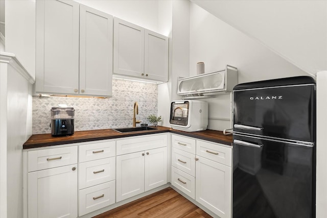 440 Ridgestone Dr, Franklin, TN 37064 - kitchen featuring freestanding refrigerator, wood counters, decorative backsplash, and white cabinetry