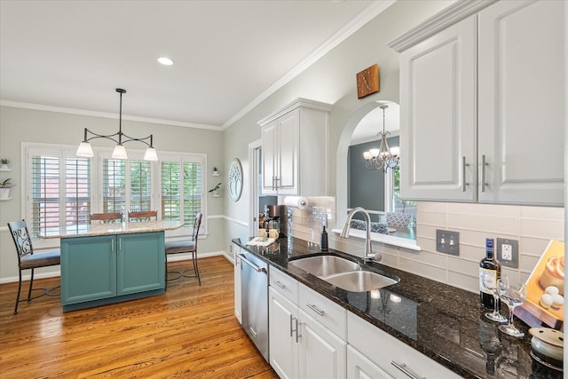 440 Ridgestone Dr, Franklin, TN 37064 - kitchen featuring a chandelier, light wood finished floors, white cabinets, tasteful backsplash, and stainless steel dishwasher