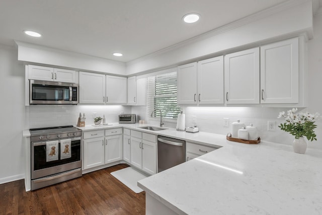 933 Percy Warner Blvd, Nashville, TN 37205 - kitchen with stainless steel appliances, a sink, white cabinetry, tasteful backsplash, and ornamental molding