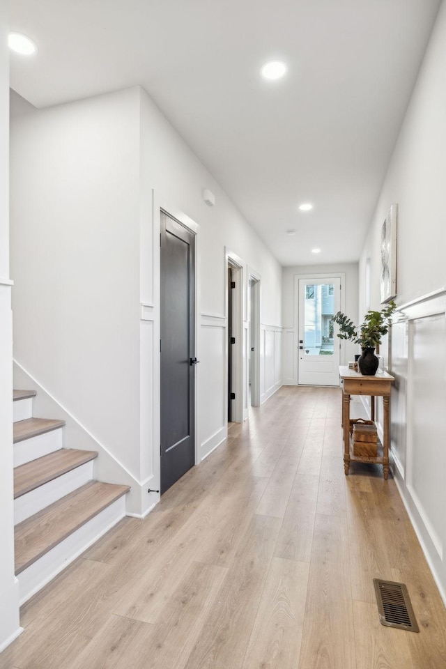 1734A Kellow St, Nashville, TN 37208 - hallway with light wood finished floors, a decorative wall, wainscoting, recessed lighting, and stairway